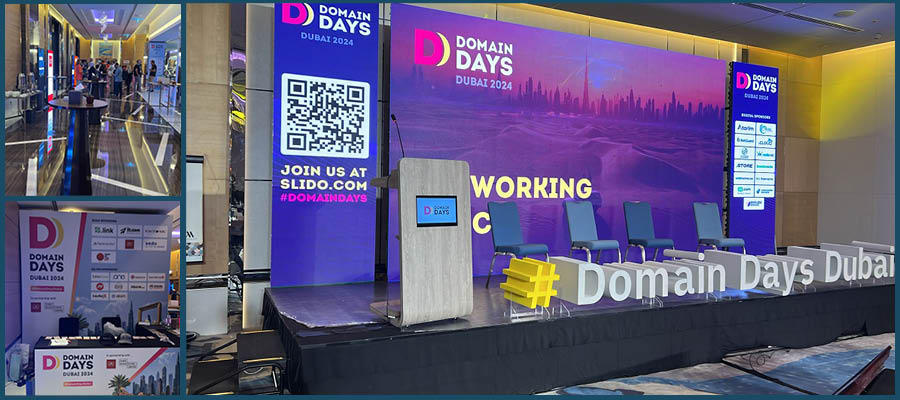 Bühne und Networking-Bereich der Dubai Domain Days 2024 mit Banner und Hashtag-Schild